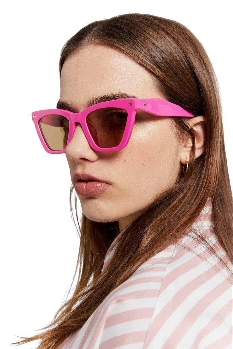 Naked Pear Karen Walker Spellbound cat-eye sunglasses in fuchsia acetate with brown lenses worn by a model
