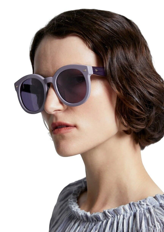 Model wearing Naked Pear Karen Walker Super Duper Strength oversized round lilac plum bio-acetate sunglasses