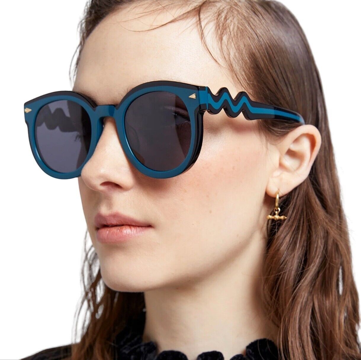 Naked Pear Karen Walker Super Wavy Duper round teal and black bio-acetate sunglasses with wavy arms on a model
