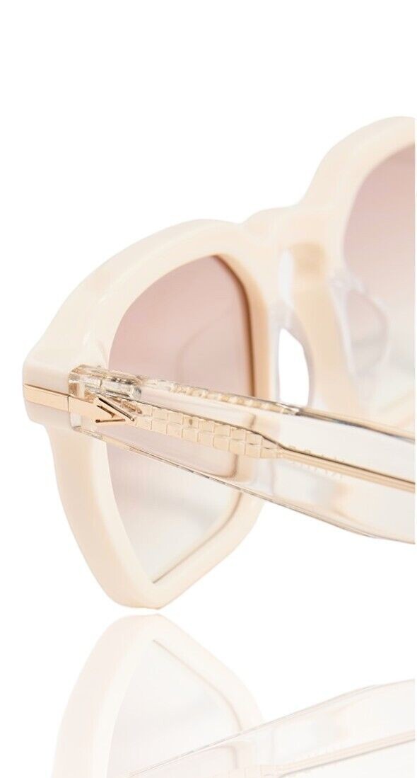 Naked Pear Karen Walker Trillion sunglasses in ivory sand acetate with clear temples and gold arrow hardware detail.