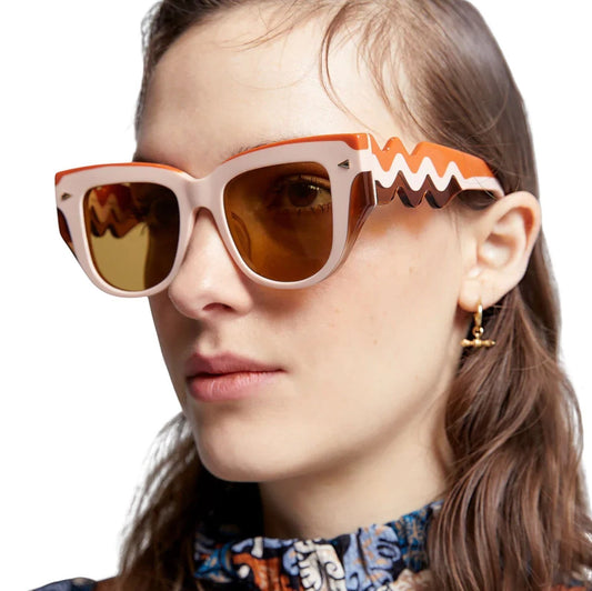 Naked Pear Karen Walker True North Wave cat eye sunglasses in orange, pink, and peach acetate with wavy arms.