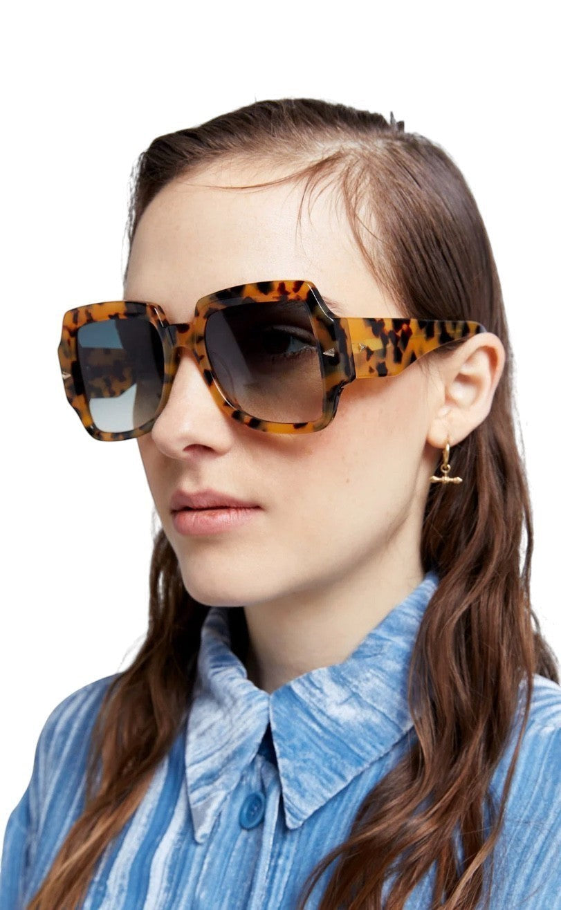 Model wearing Naked Pear Karen Walker Ultra Vulture oversized square tortoise shell bio-acetate sunglasses