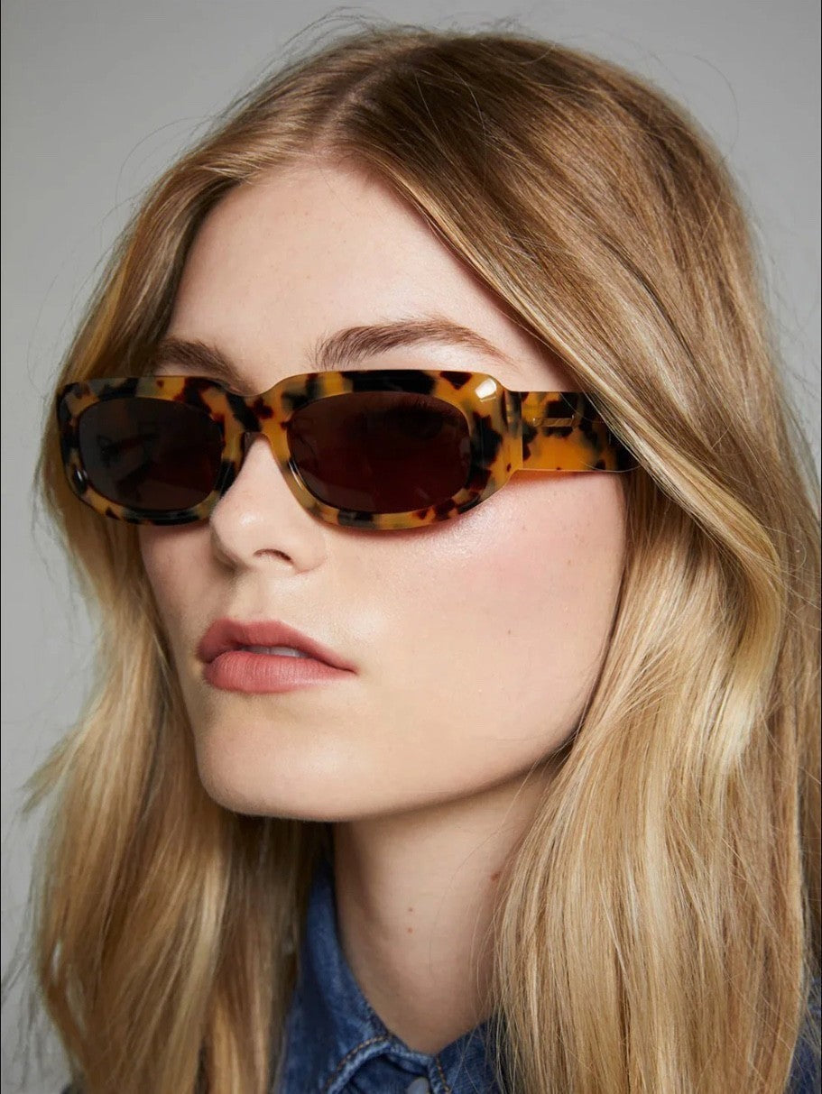 Naked Pear Karen Walker Zahra B rectangle sunglasses in crazy tortoise shell with brown lenses on a blonde model