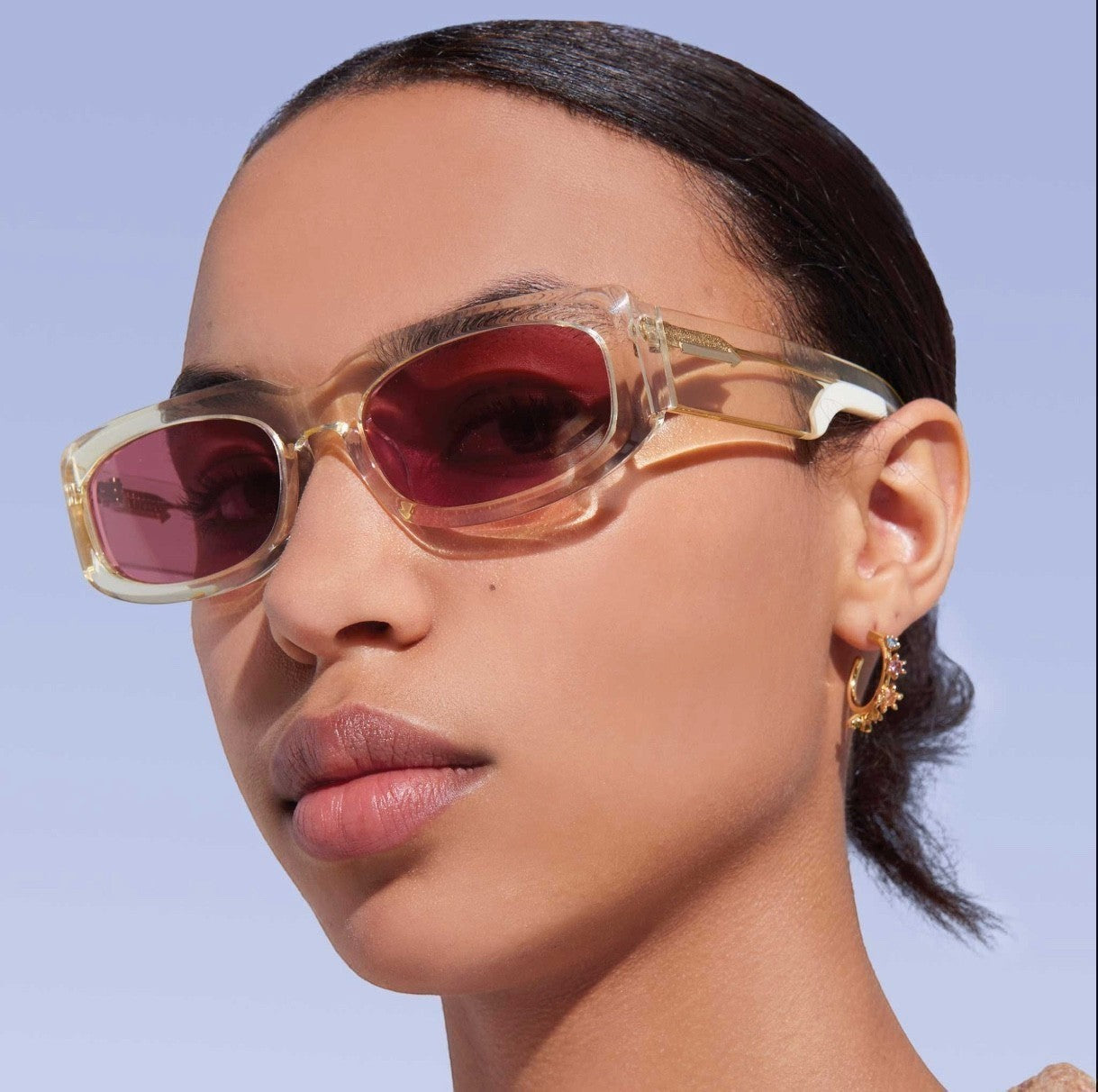 Naked Pear Karen Walker Zahra B rectangle sunglasses with vintage clear acetate frames and dusty pink lenses on a model