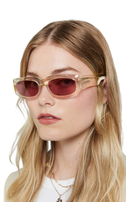 Naked Pear Karen Walker Zahra B rectangle sunglasses with vintage clear frames and dusty pink lenses on a model