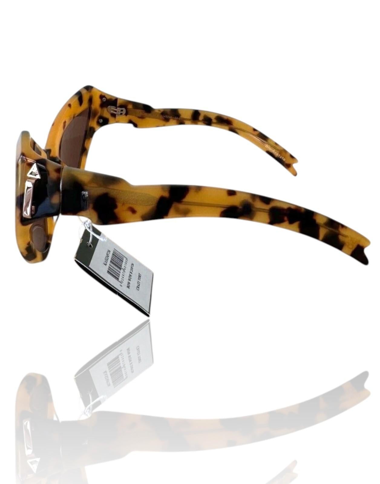 Sunglasses with tortoiseshell frame and clear lens on a white background