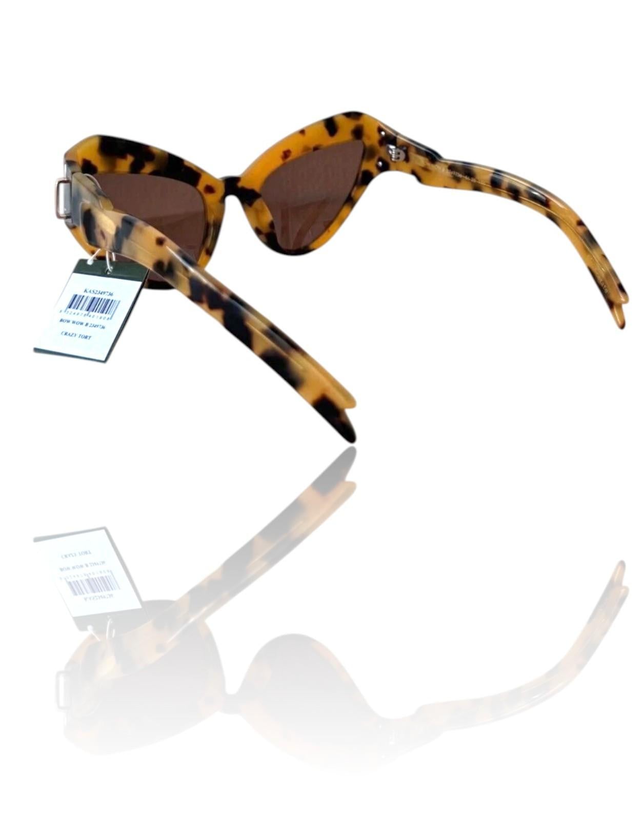 Sunglasses with tortoiseshell frame and brown lenses on a white background