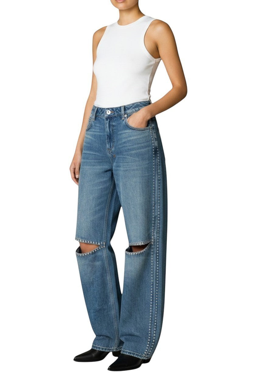Naked Pear Ksubi Low Rider jeans in indigo denim with silver studs and knee cutouts worn with a white tank top