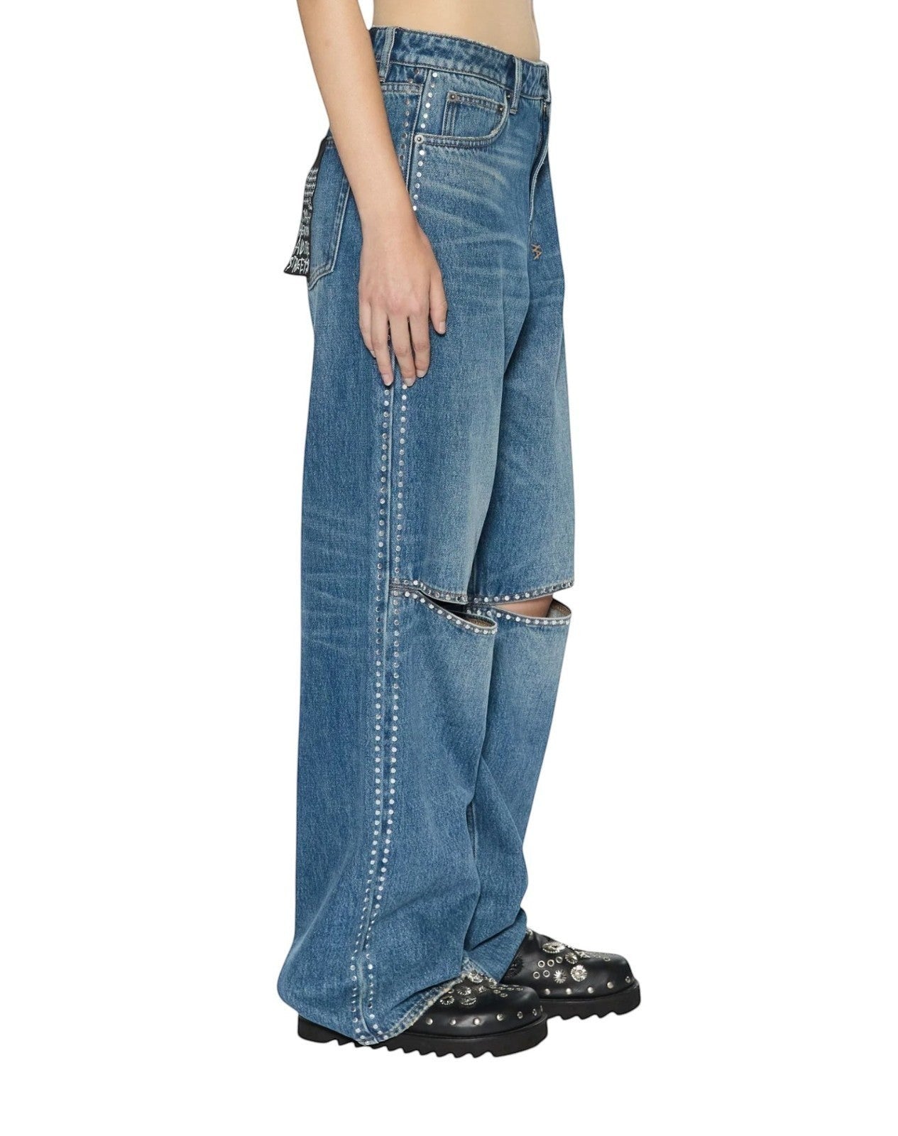 Naked Pear Ksubi Low Rider jeans in indigo denim with silver studding and knee cutouts, side profile view.