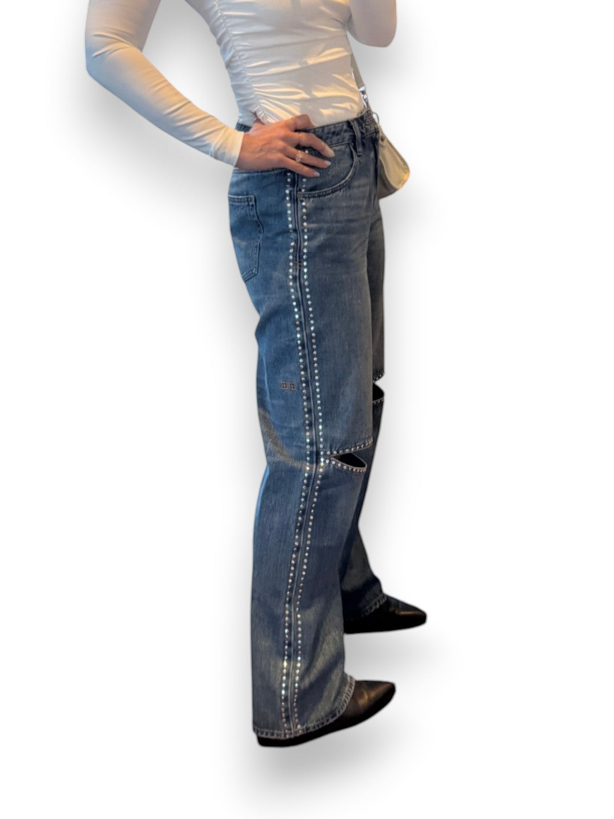 Naked Pear Ksubi Low Rider jeans in indigo denim with silver stud detailing and knee cutouts on a model