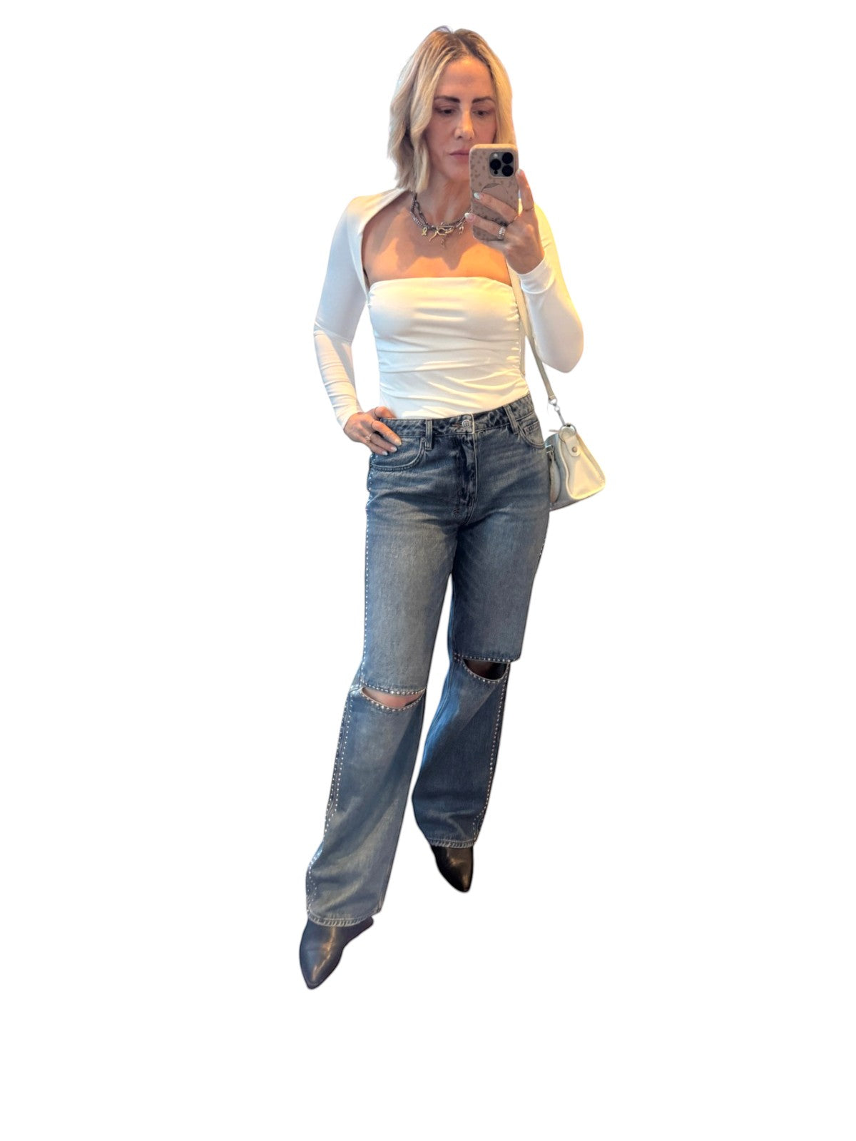 Naked Pear Ksubi Low Rider jeans in indigo denim with silver studs and knee cutouts worn by a woman
