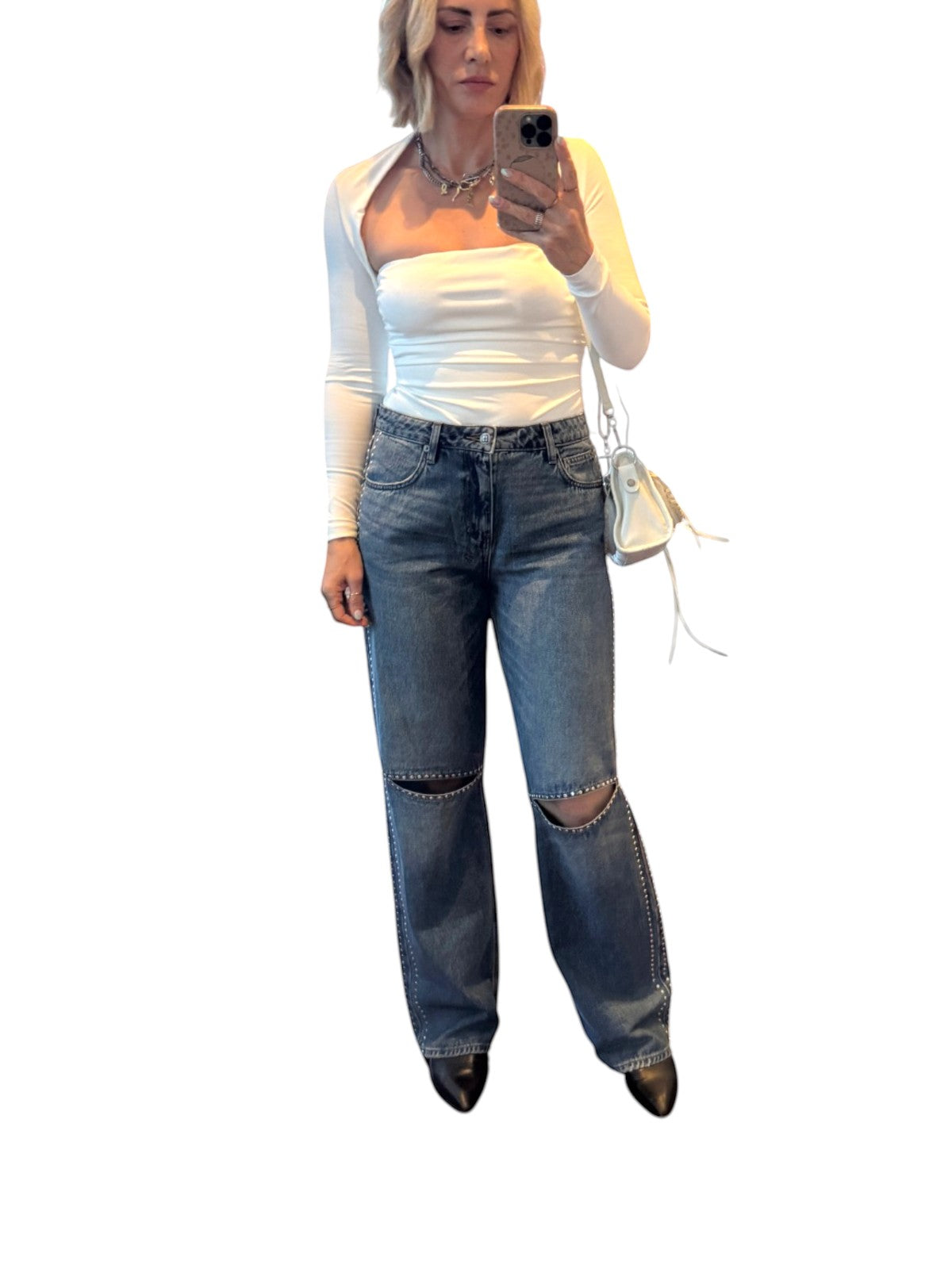 Naked Pear Ksubi Low Rider jeans in indigo denim with silver studs and knee cutouts worn by a woman