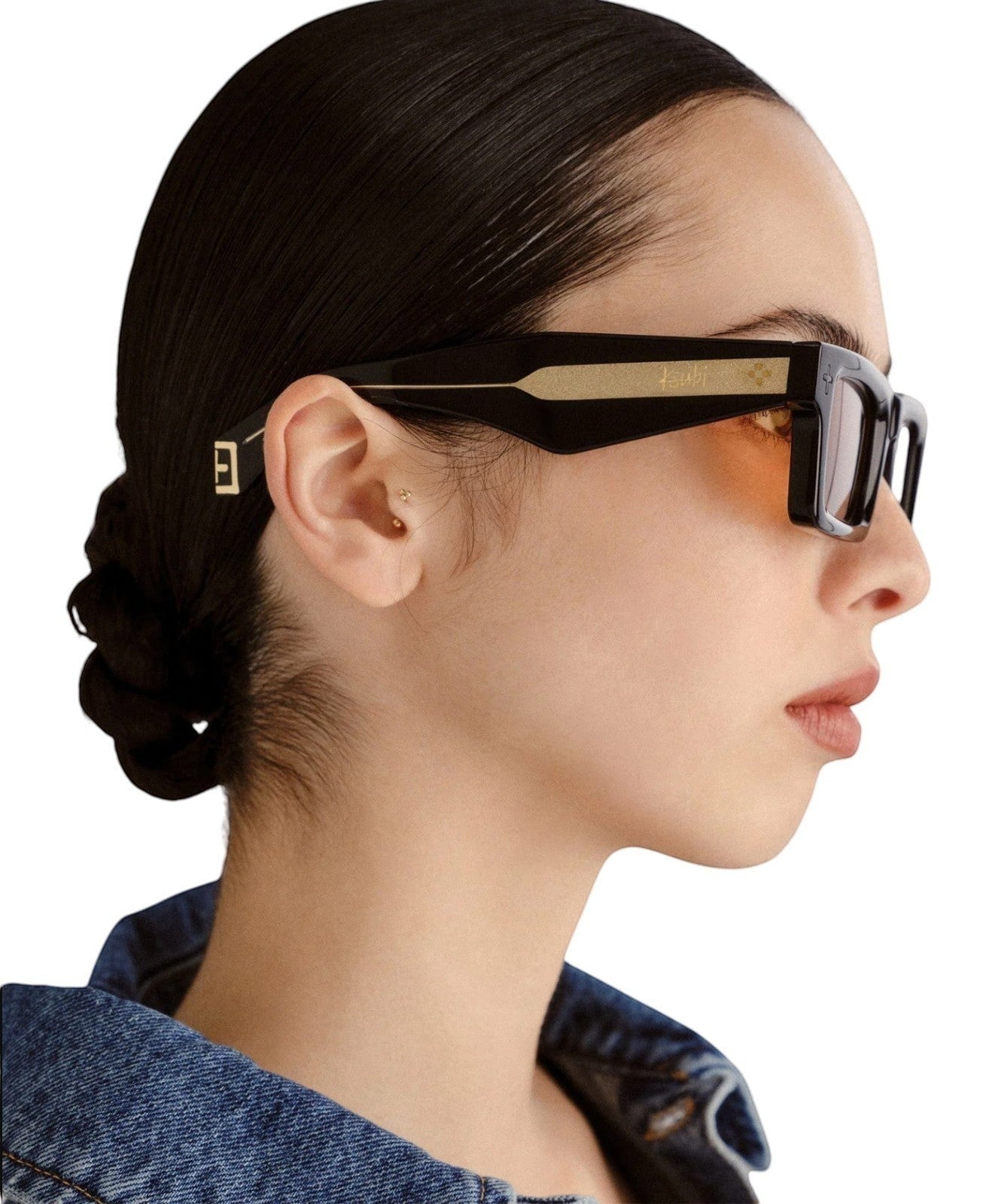 Naked Pear Ksubi Smiths II sunglasses featuring a black acetate frame, gold temple detail, and amber lenses on a model