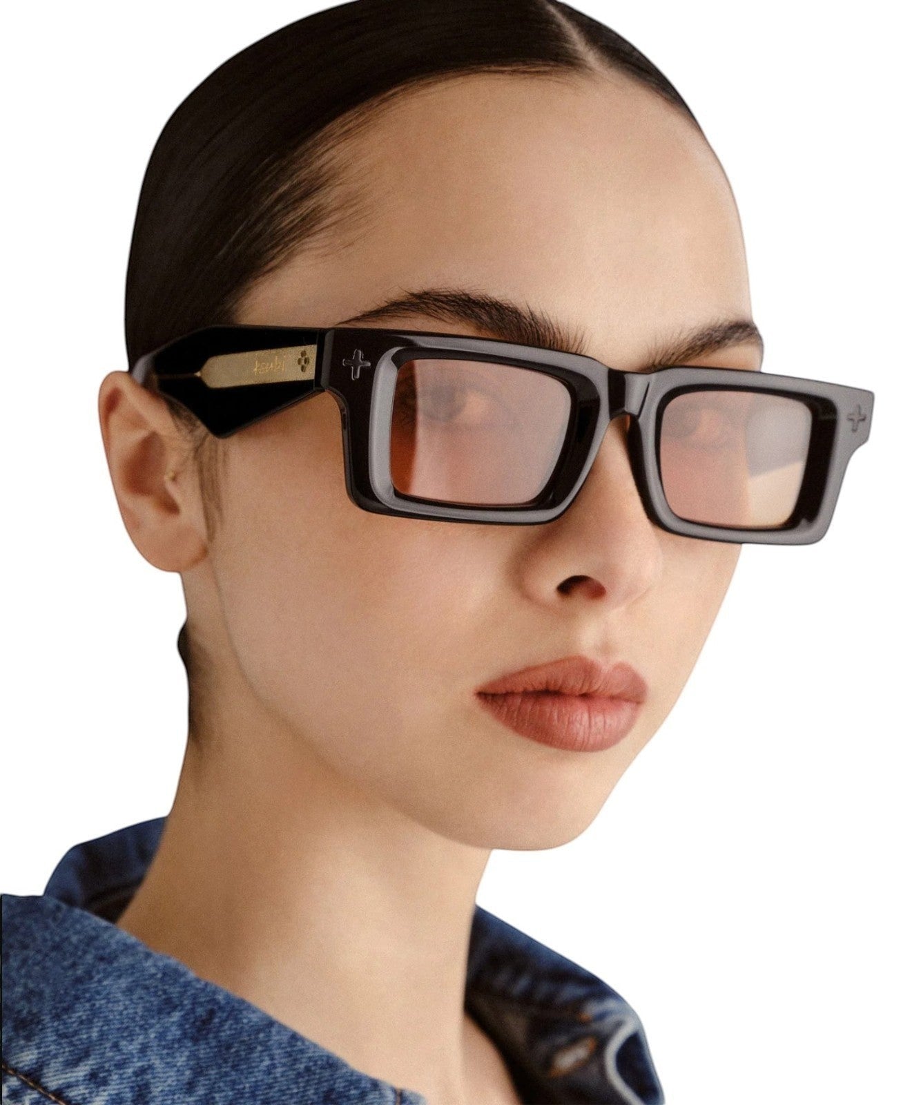 Model wearing Naked Pear Ksubi Smiths II rectangular black acetate sunglasses with amber lenses and gold temple detail