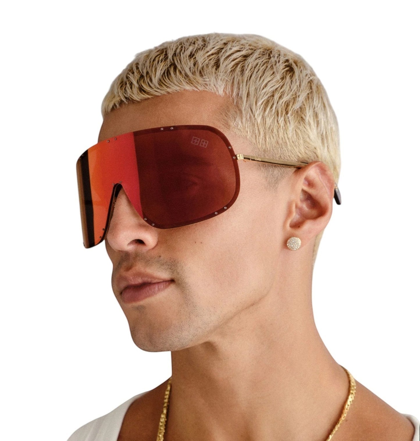 Model wearing Naked Pear Ksubi Tyrell shield sunglasses with gold frames and red mirror lenses