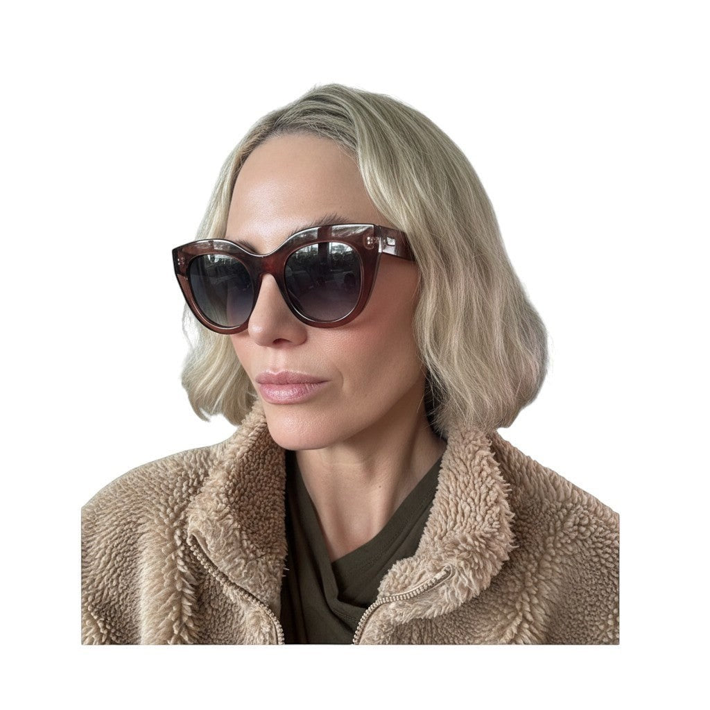 Naked Pear Le Specs Air Heart cat eye sunglasses in smokey pink with grey gradient lenses worn by a blonde woman