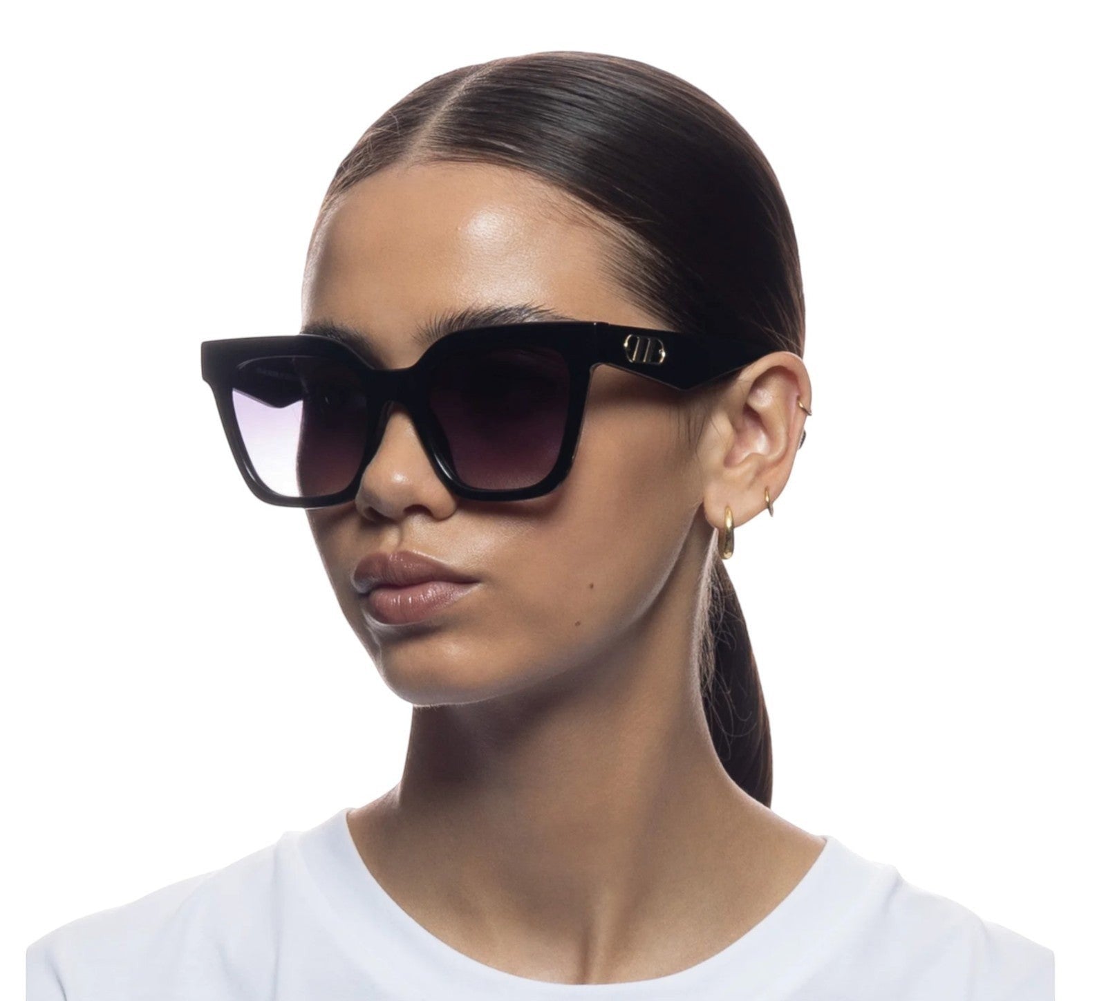 Naked Pear Le Specs Star Glow oversized black cat-eye sunglasses with smoke gradient lenses on a model