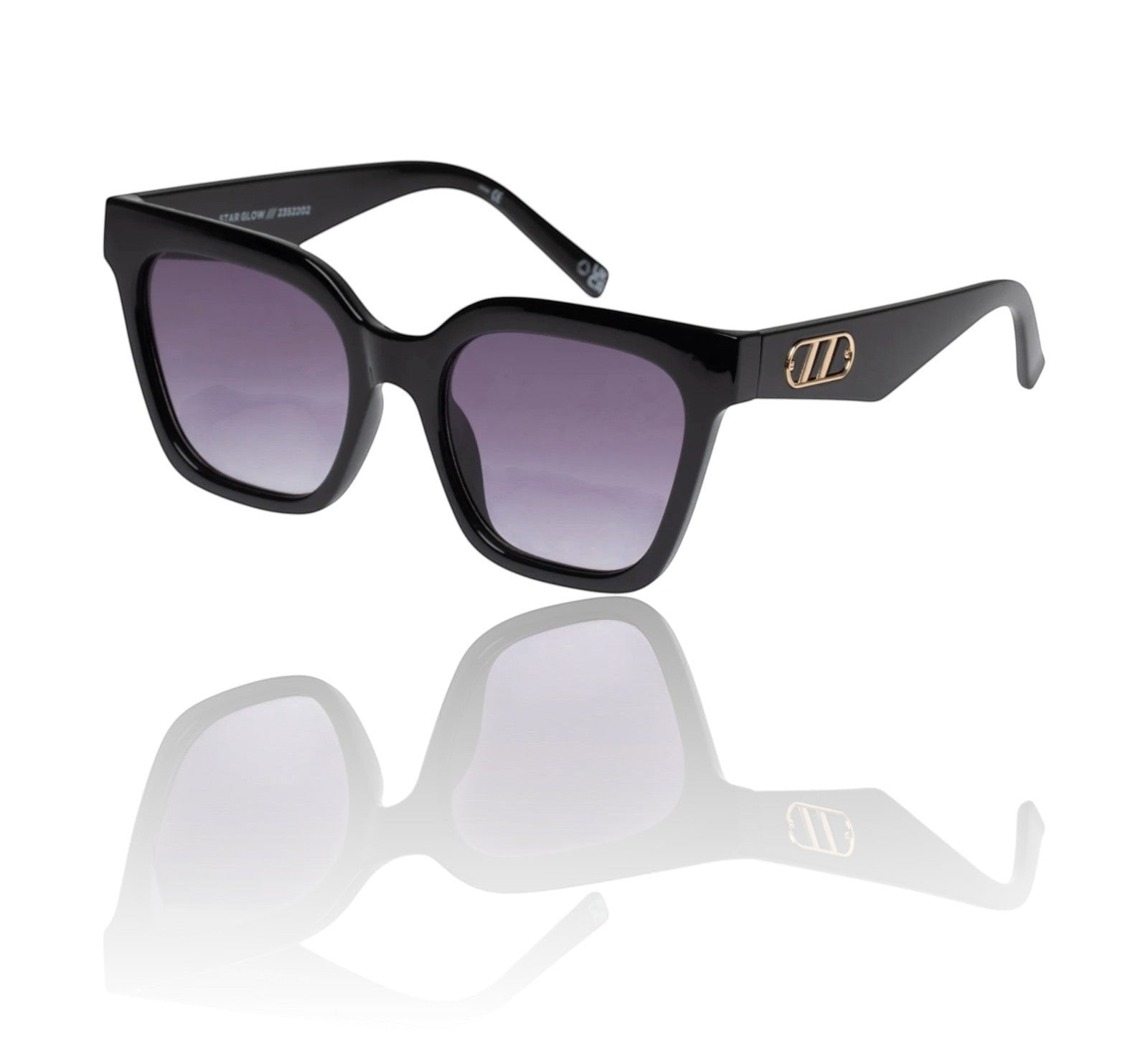 Naked Pear Le Specs Star Glow black oversized cat-eye sunglasses with smoke gradient lenses and gold temple hardware.