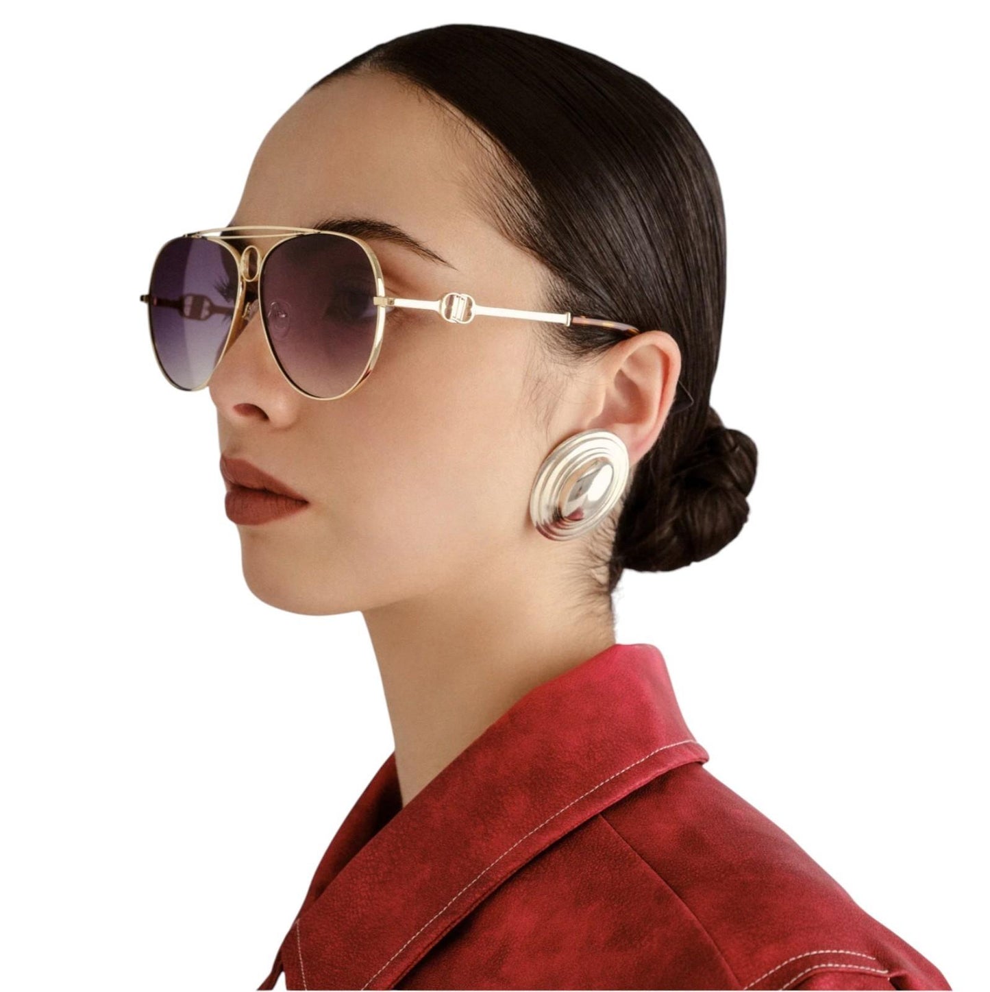 Woman wearing gold sunglasses and a red jacket on a white background
