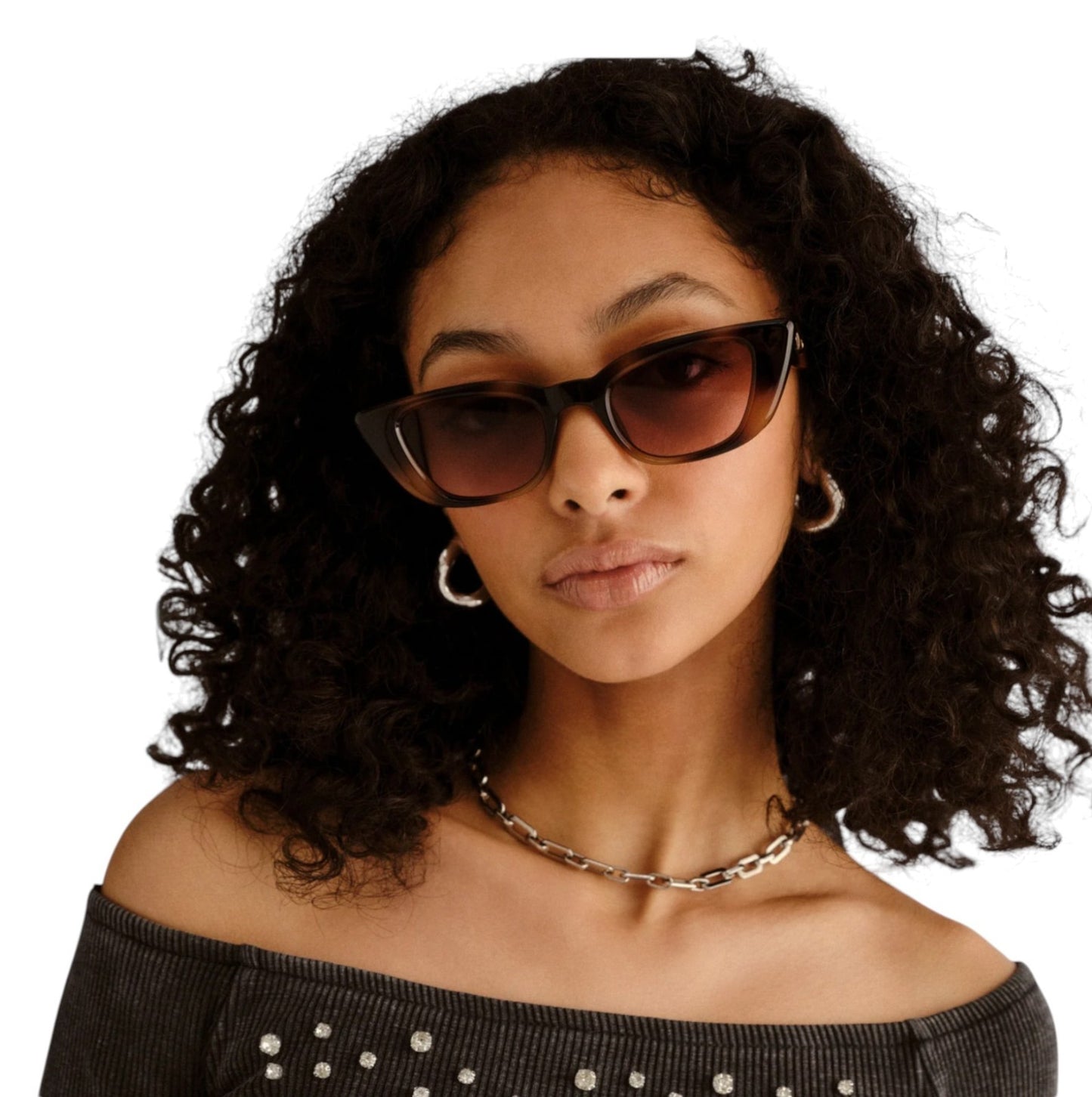 Woman wearing sunglasses with a plain background