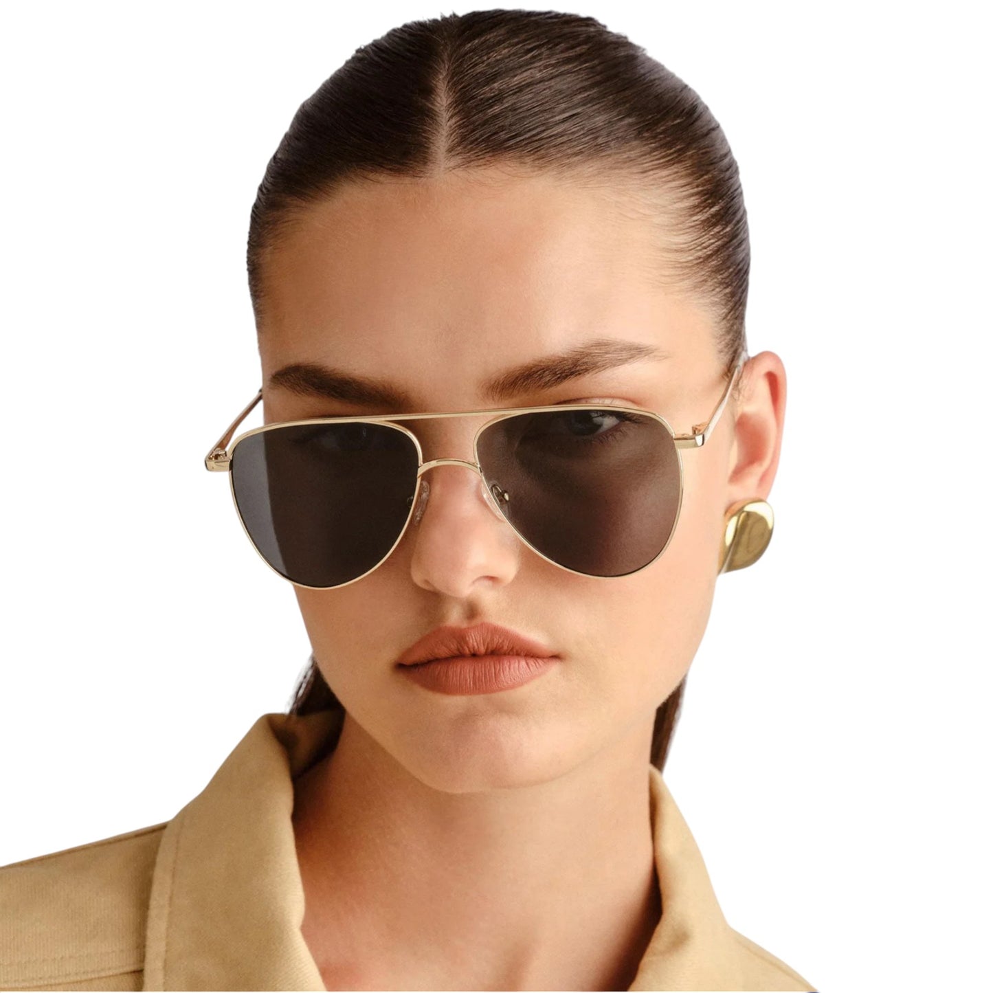 Woman wearing gold-framed sunglasses with a plain background
