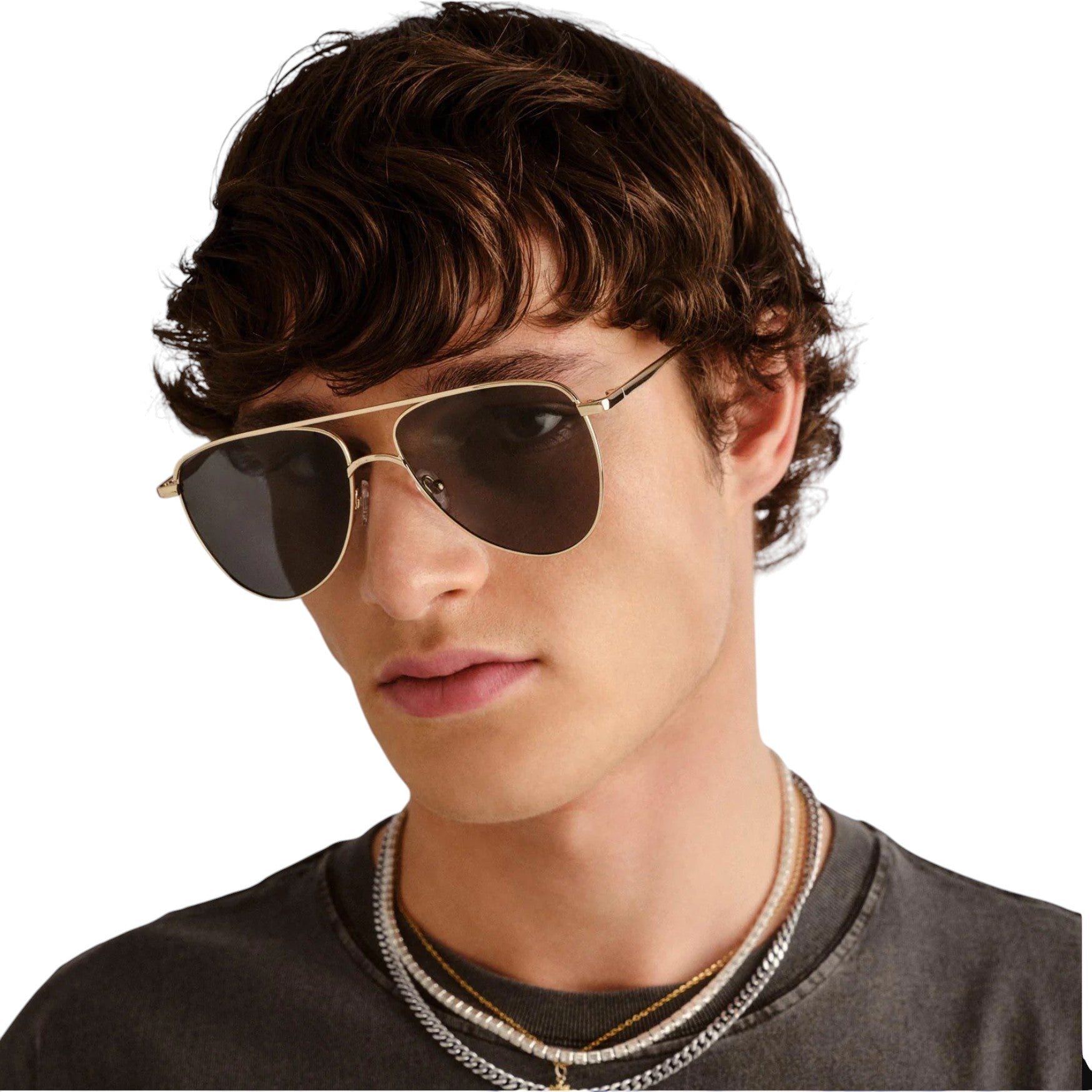 Person wearing gold-framed sunglasses with a plain background