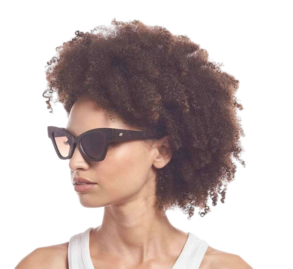 Woman wearing cat-eye sunglasses with a white background