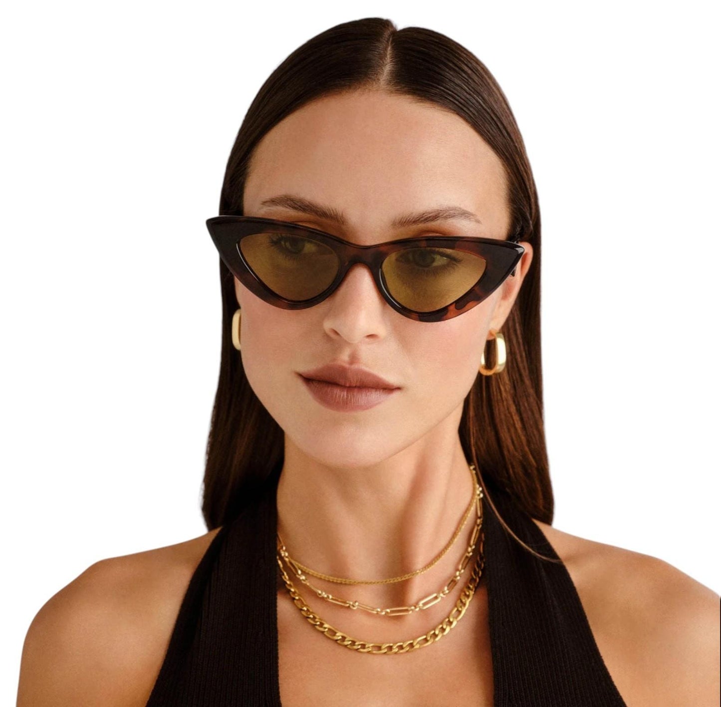 Woman wearing cat-eye sunglasses and gold jewelry on a white background