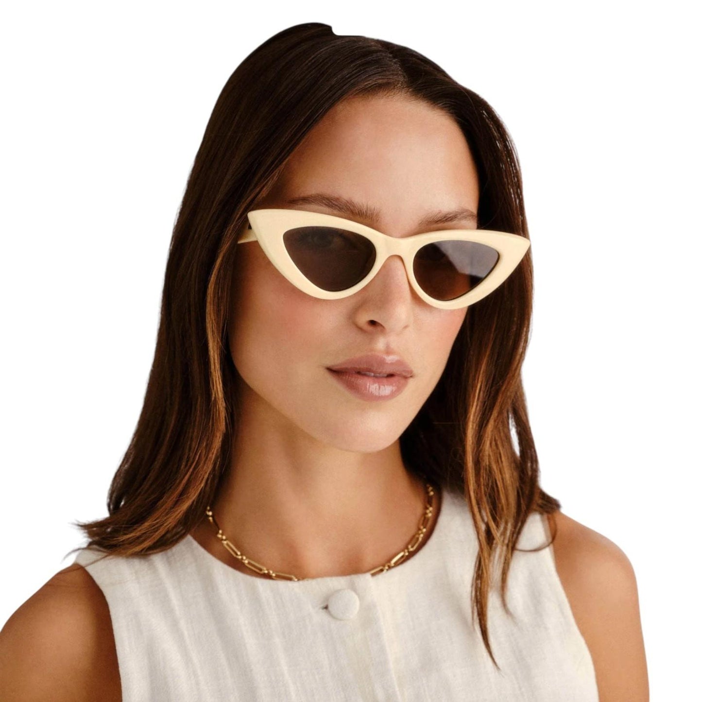 Woman wearing cat-eye sunglasses with a plain background
