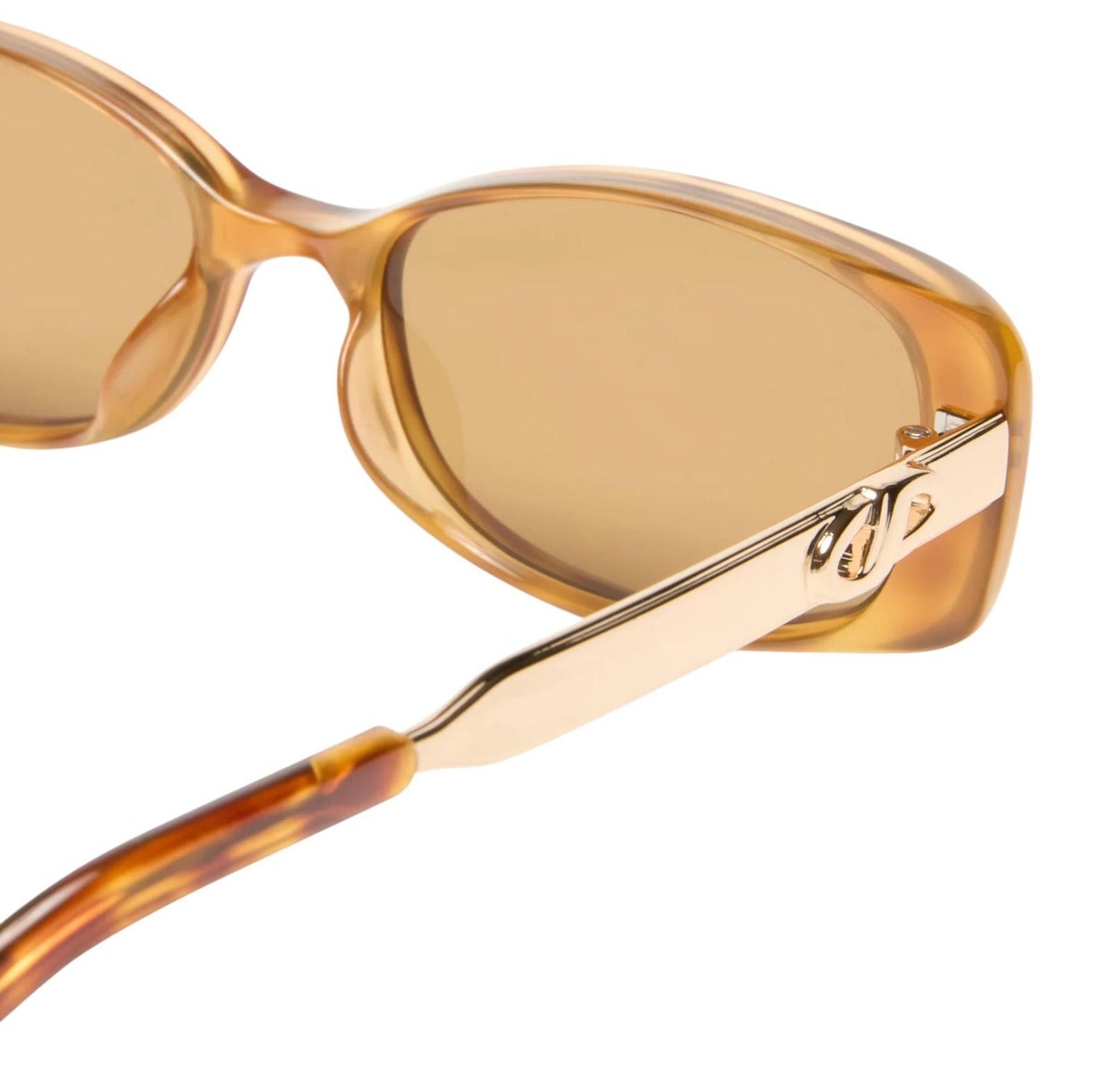 Sunglasses with gold frame and brown lenses on a white background