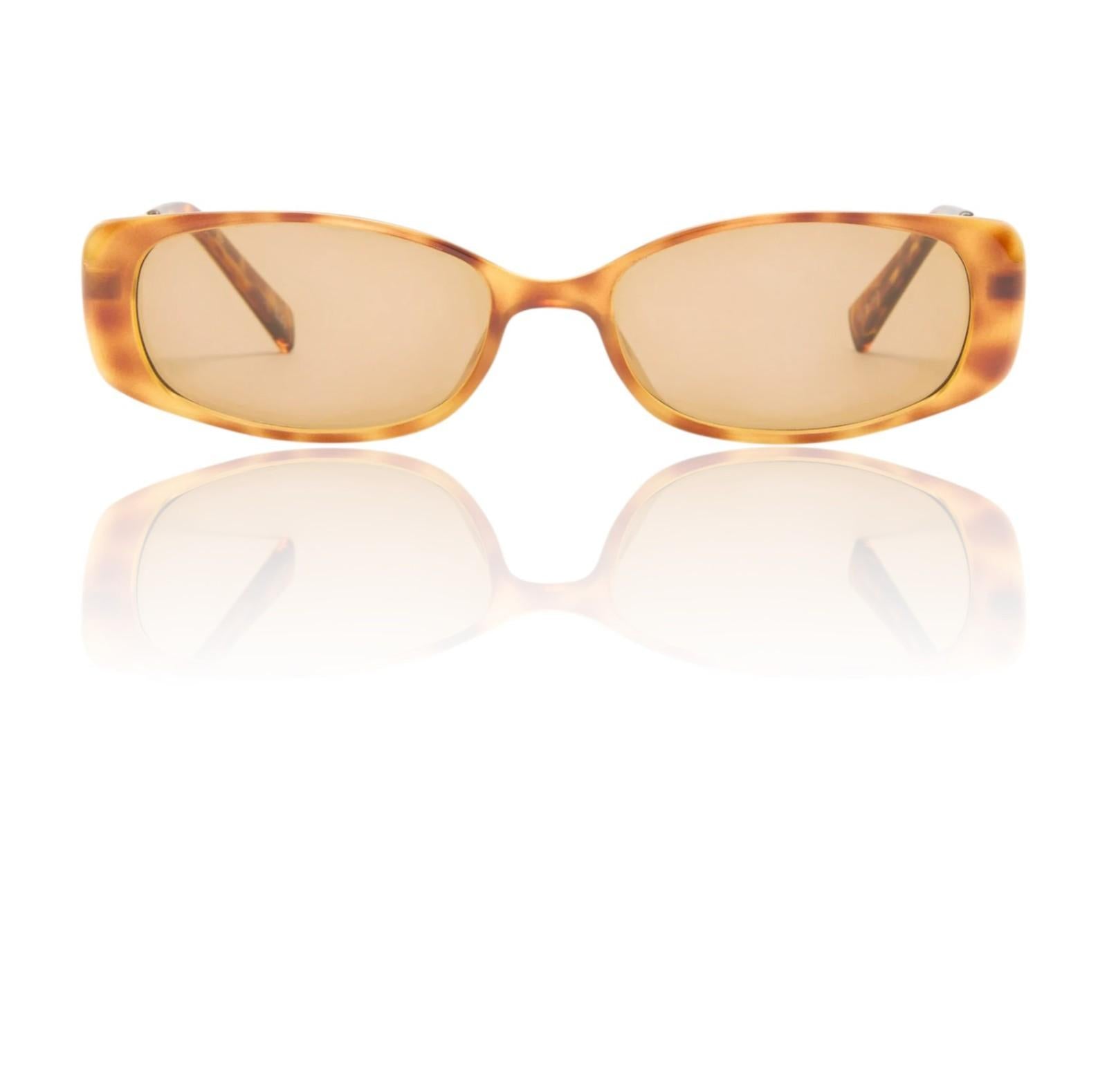 Sunglasses with tortoiseshell frame and amber lenses on a white background