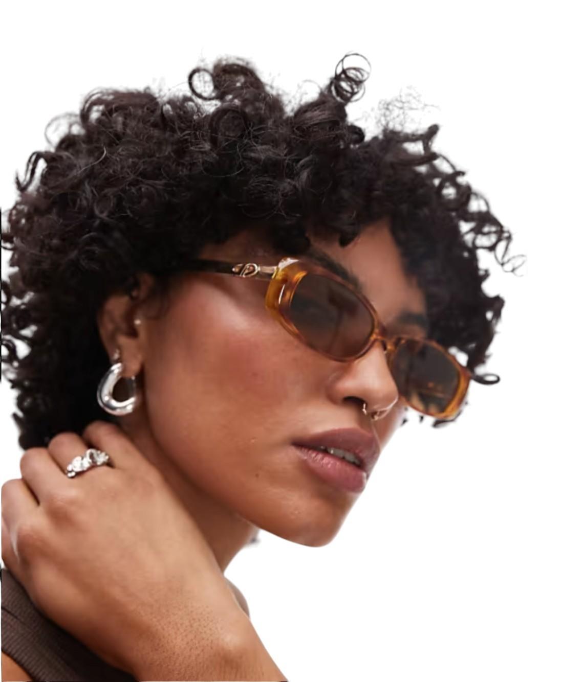 Woman wearing sunglasses with a neutral background