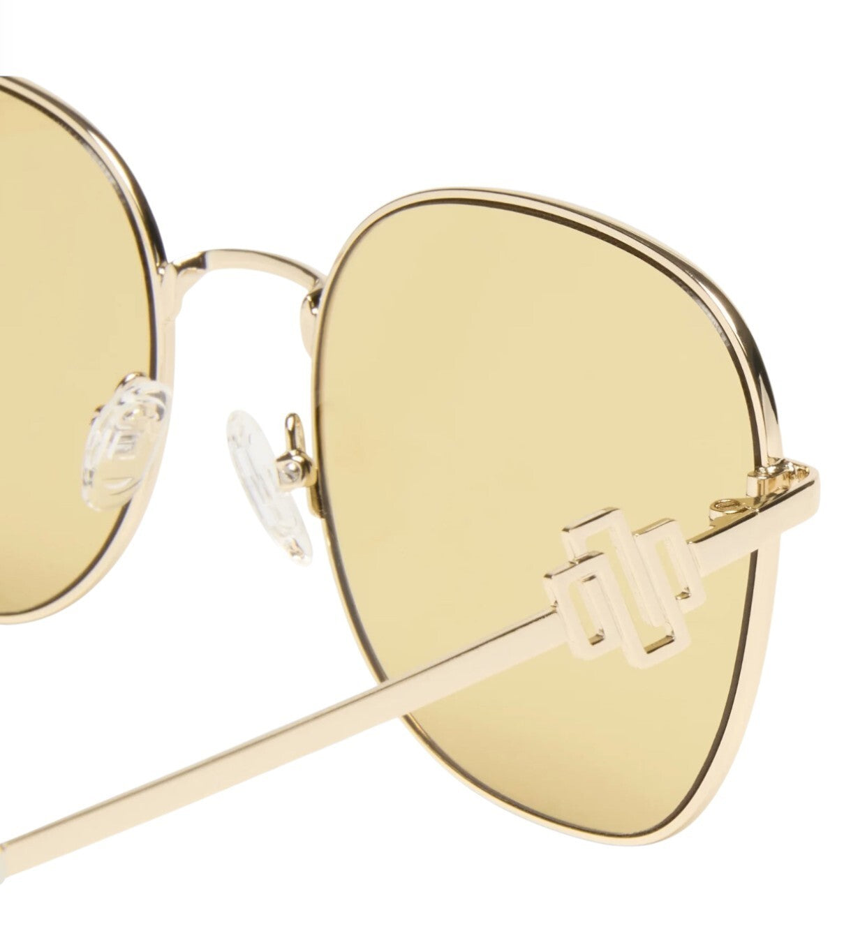Gold-framed sunglasses with yellow lenses on a white background