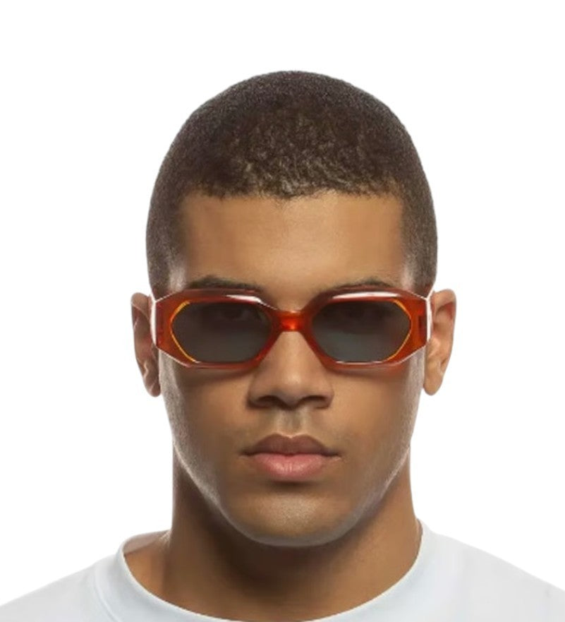 Person wearing a pair of red sunglasses on a white background