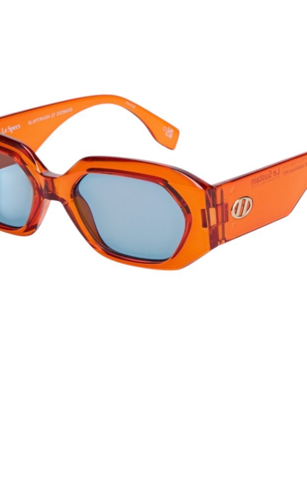 Orange sunglasses with a clear lens on a white background