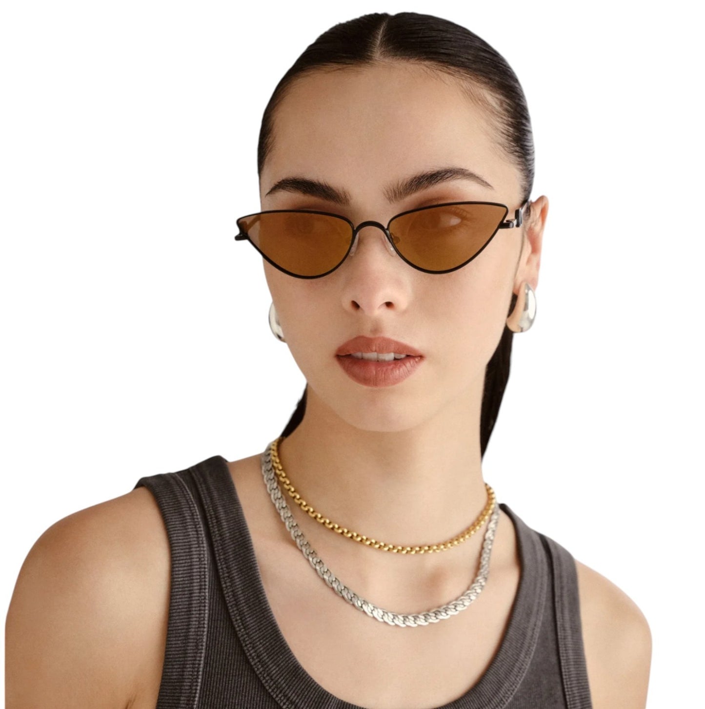 Woman wearing cat-eye sunglasses and layered necklaces on a white background