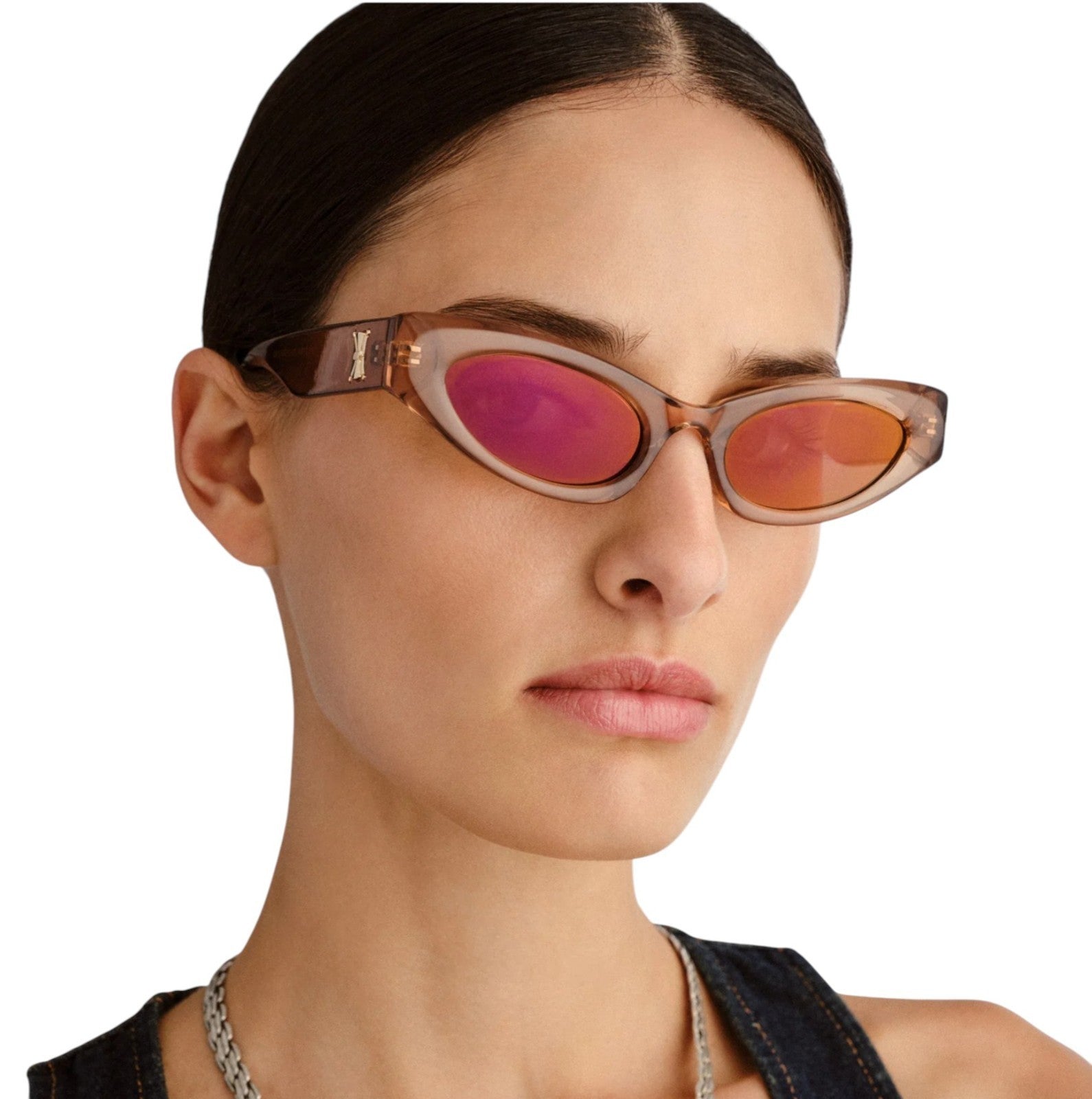Sunglasses with pink lenses worn by a model on a white background