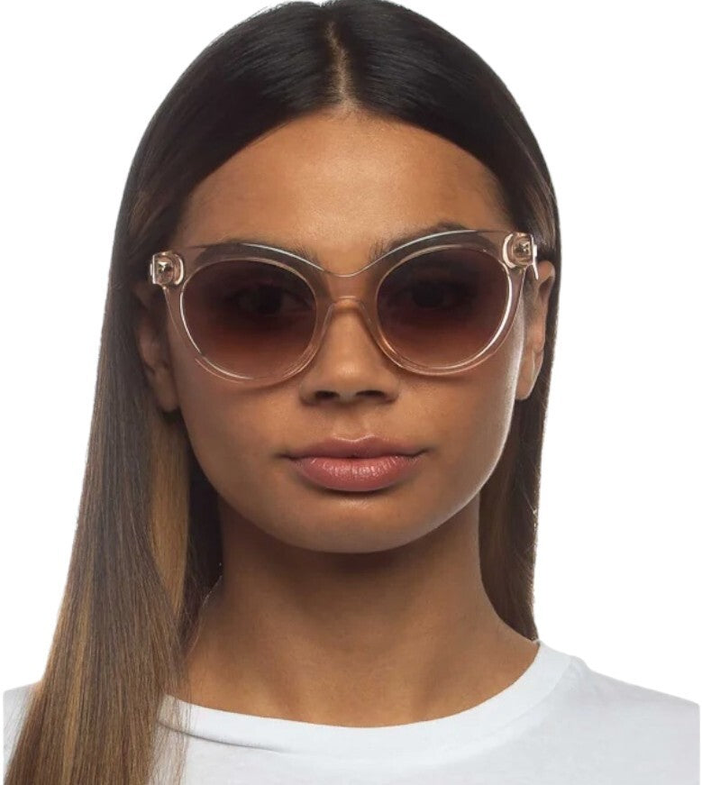 Woman wearing a pair of sunglasses with a white background