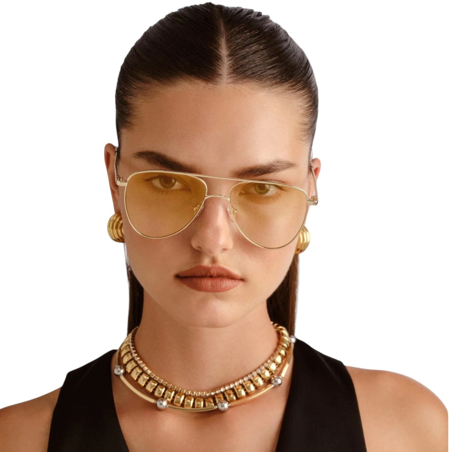 Woman wearing gold sunglasses and necklace on a white background