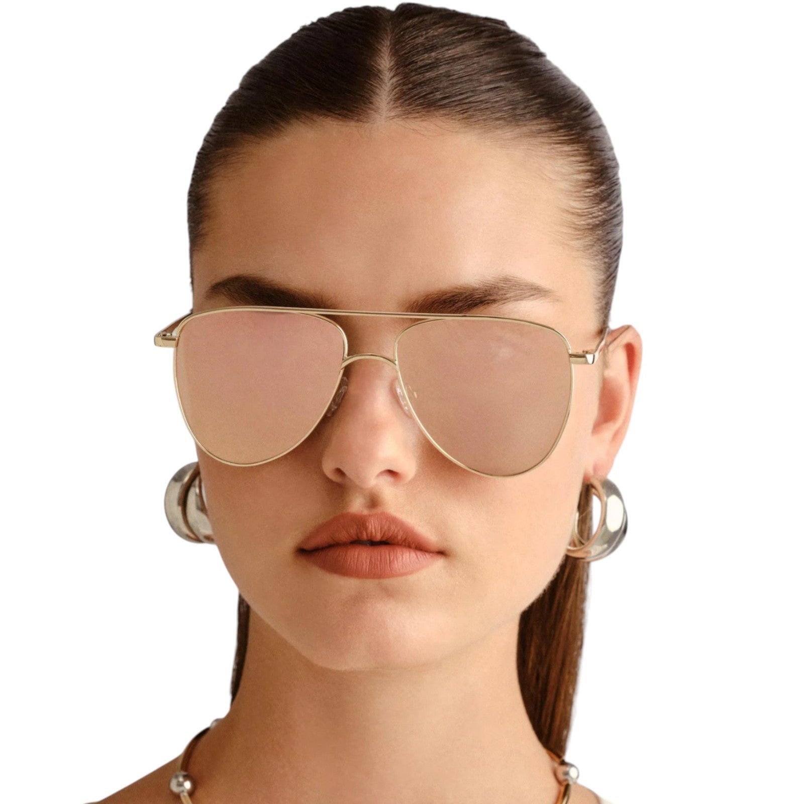 Close-up of a person wearing gold aviator sunglasses with a plain background