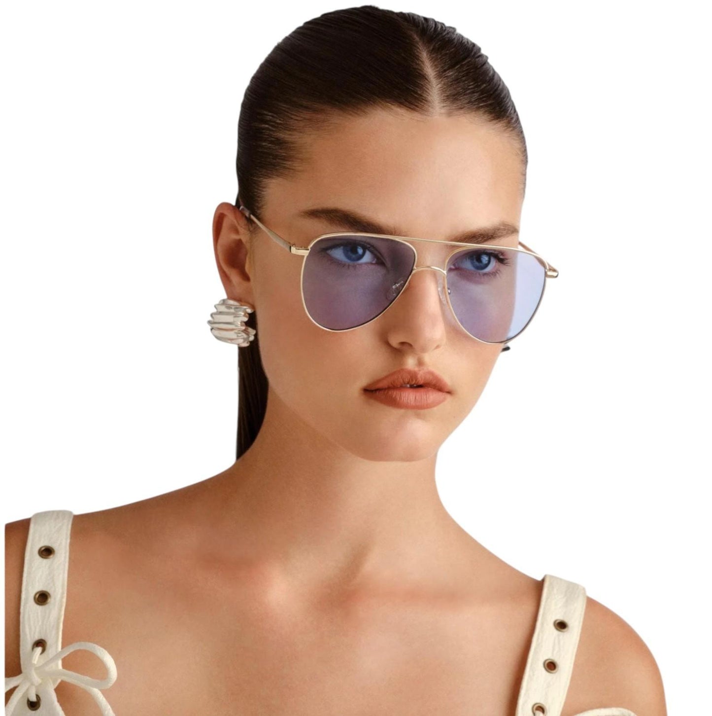 Woman wearing gold-framed sunglasses with a white background