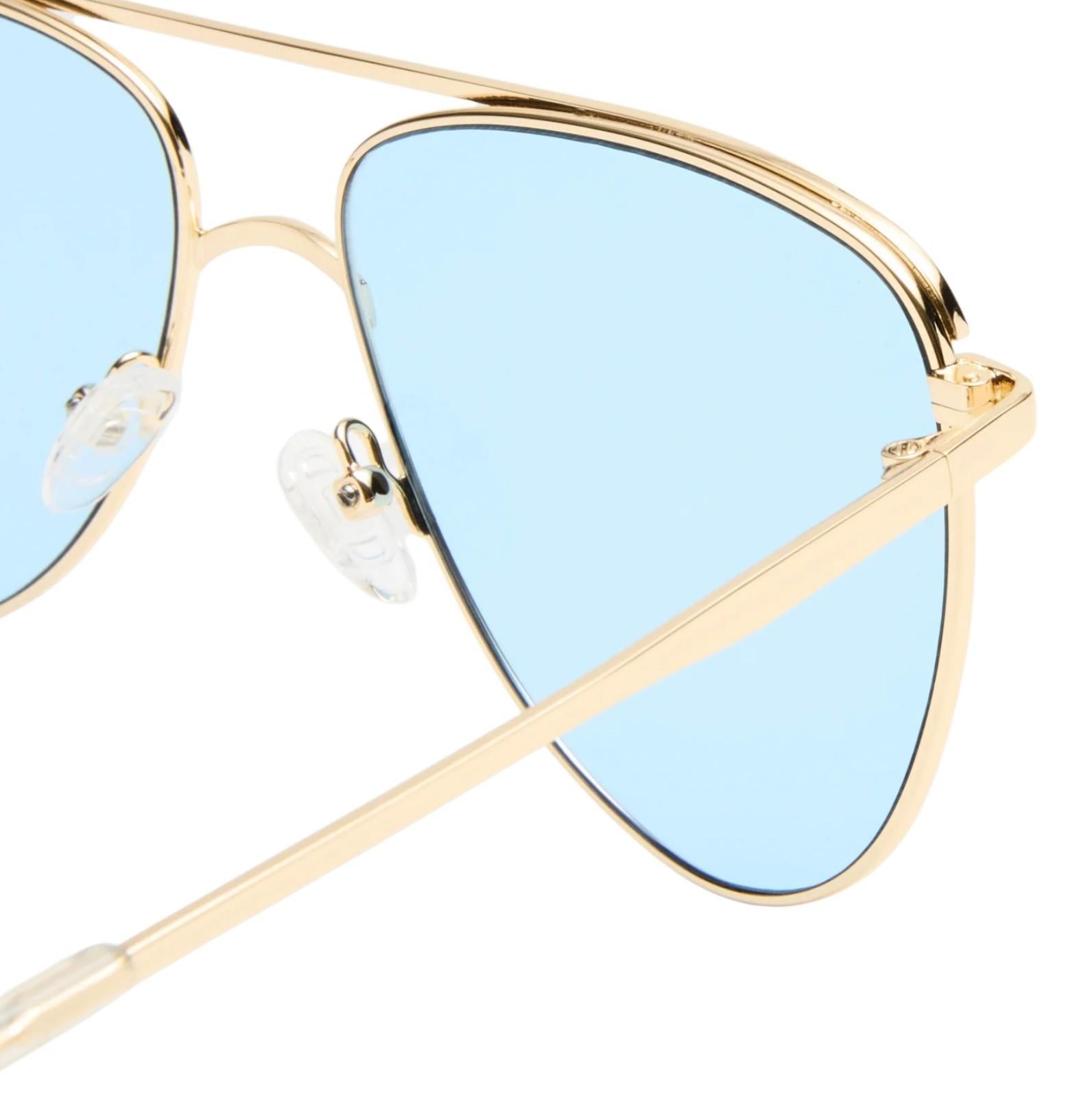 Gold-framed sunglasses with light blue lenses on a white background