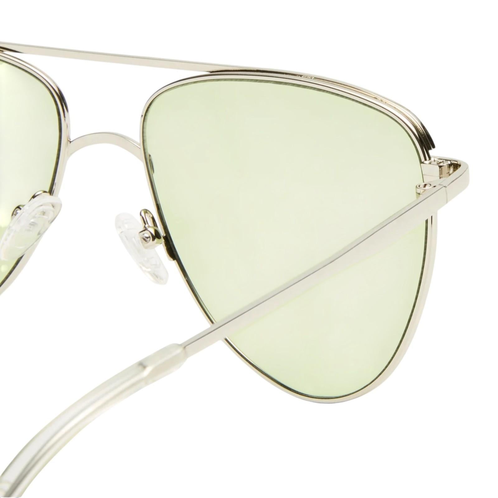 Sunglasses with green lenses and gold frames on a white background