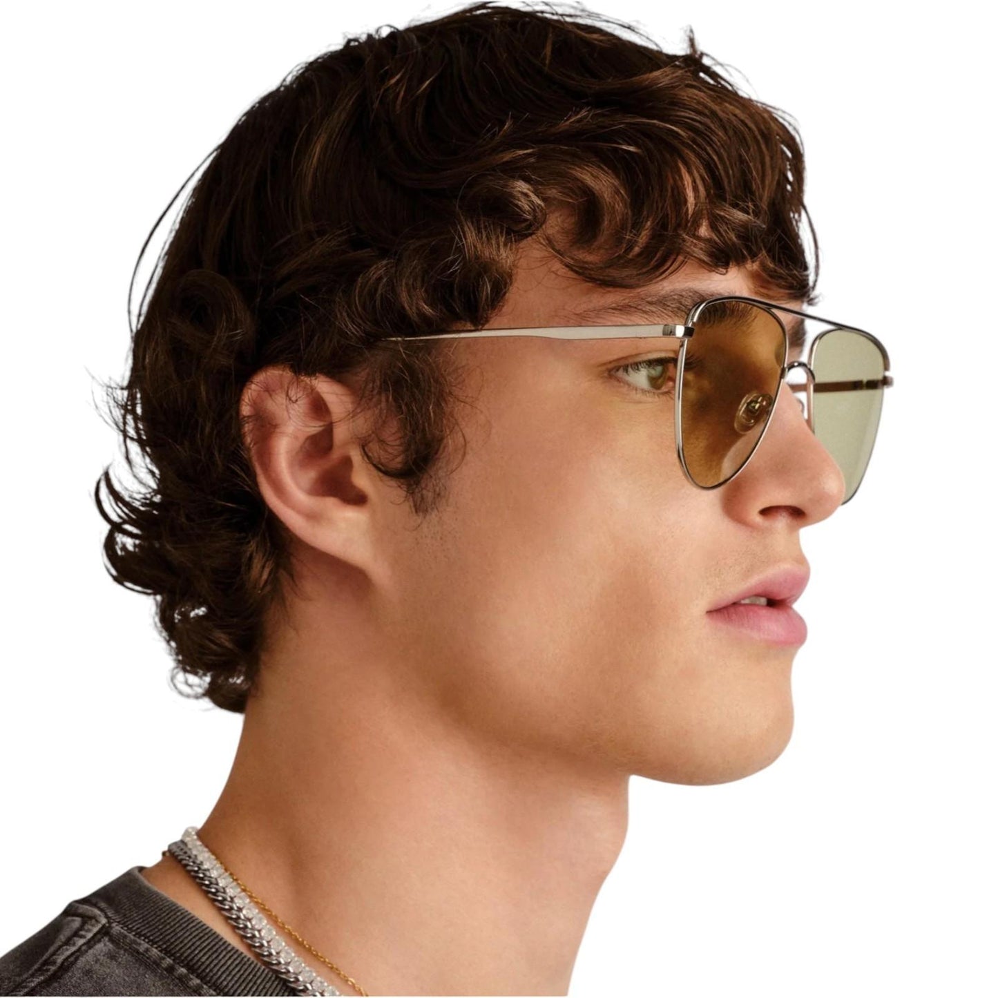 Side profile of a person wearing aviator sunglasses with a neutral background
