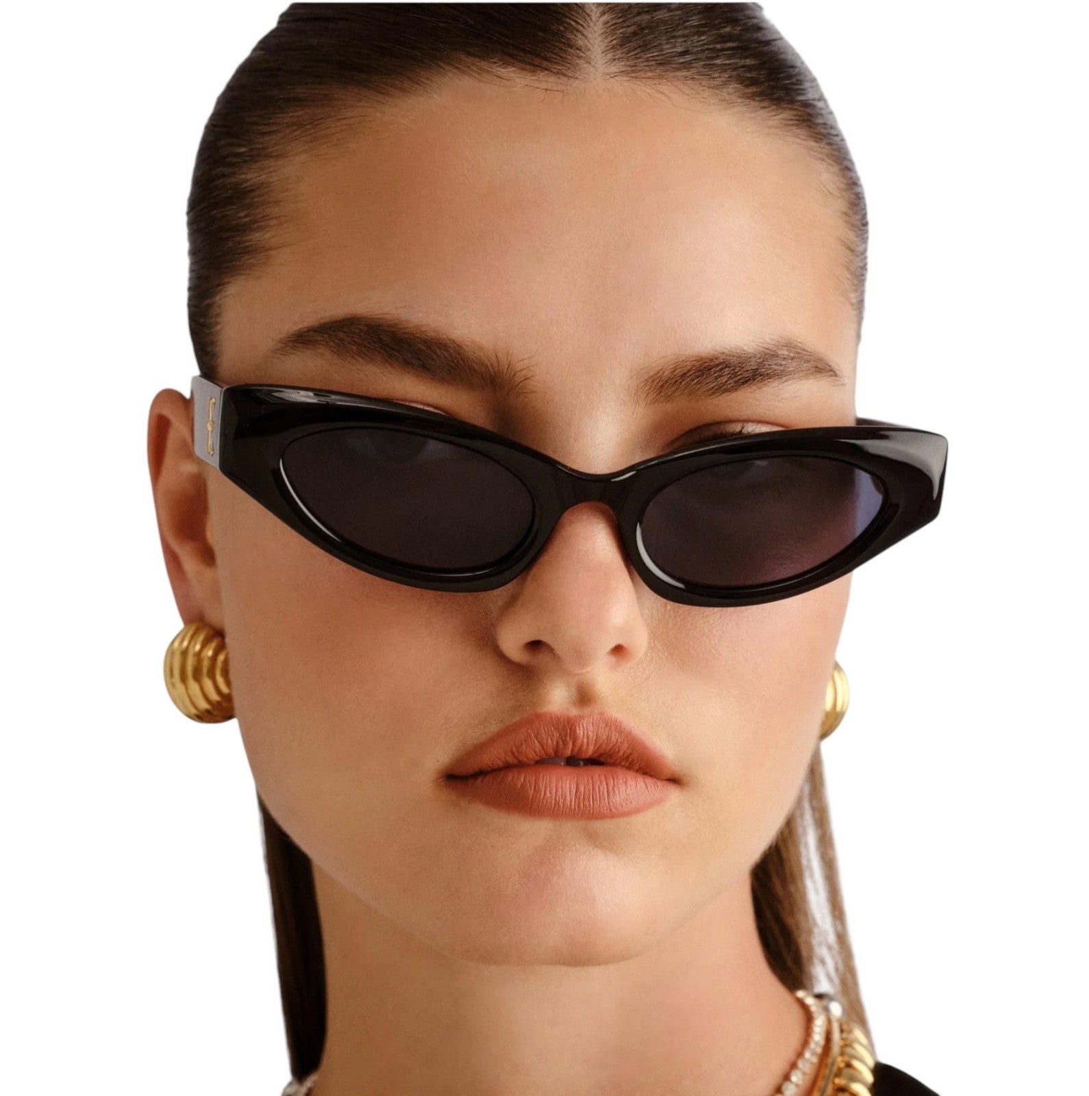 Close-up of a person wearing black cat-eye sunglasses with a plain background
