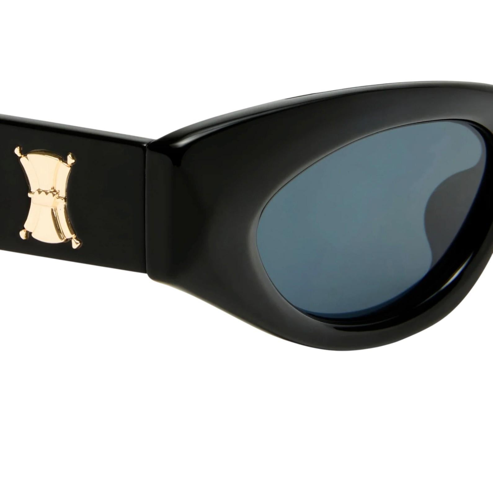 Black sunglasses with a gold emblem on the arm against a white background