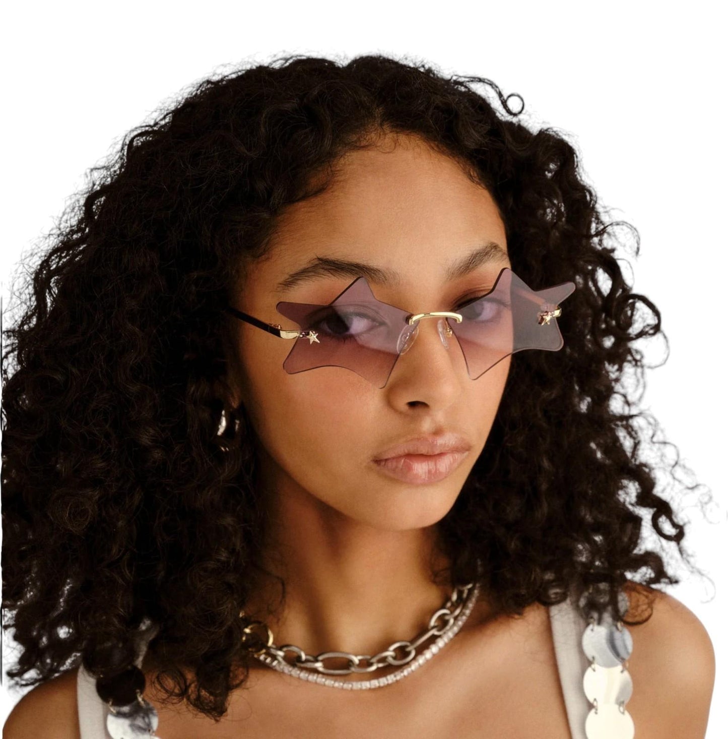 Woman wearing star-shaped sunglasses with a neutral background