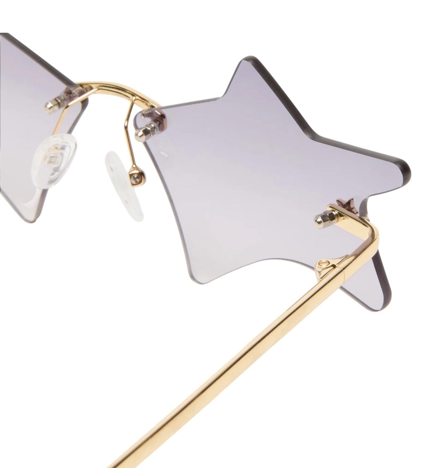 Star-shaped sunglasses with gold frame on a white background