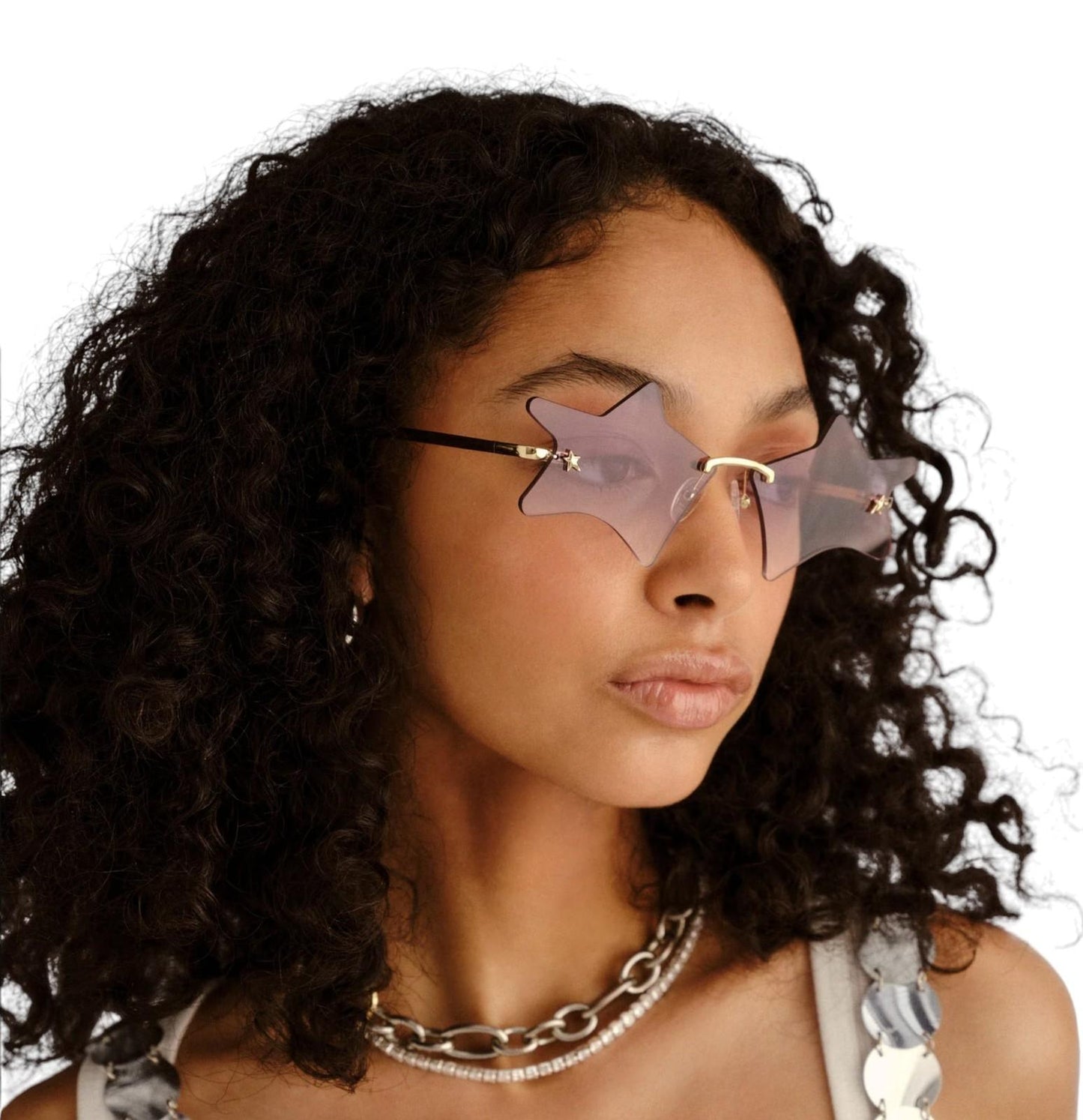 Person wearing star-shaped sunglasses with a neutral background