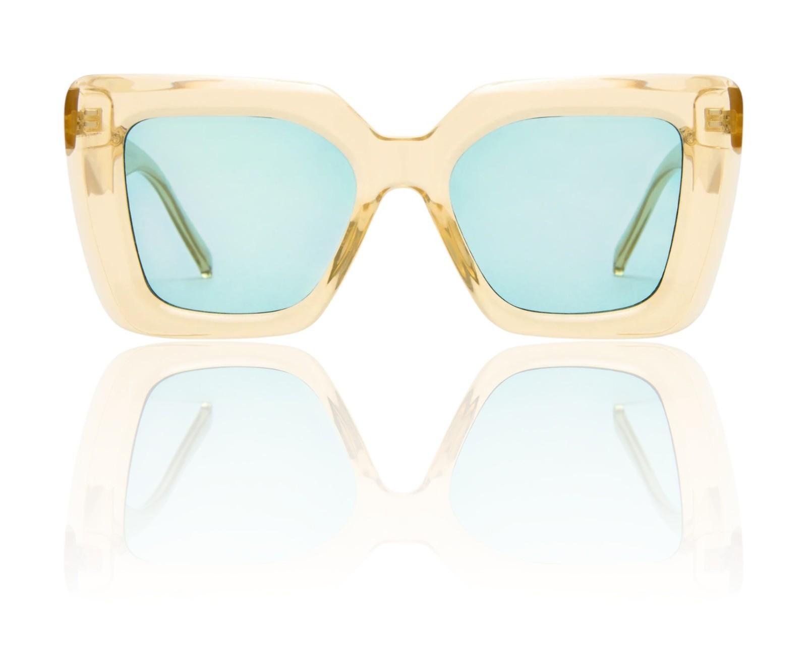 Gold-framed sunglasses with light blue lenses on a white background